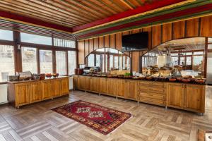 a large kitchen with wooden cabinets and a counter at Grand Cappadocia Hotel in Göreme