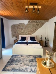 a bedroom with a large bed and a wooden ceiling at Mlýn Slavonice in Slavonice