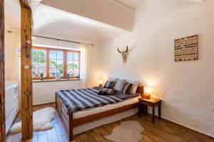 a bedroom with a bed and a window at WELLNESS FARMHOUSE Monínec in Měšetice +24 photos