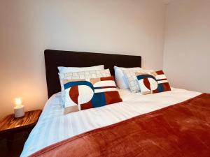 a bedroom with a bed with pillows on it at Cosy Of John Cockerill in Seraing +9 photos