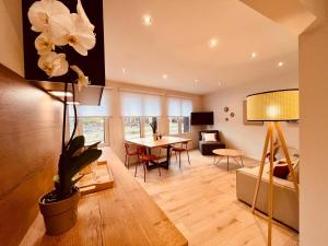 a living room with a couch and a table at Cosy Of John Cockerill in Seraing