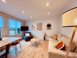 a living room with a couch and a table at Cosy Of John Cockerill in Seraing