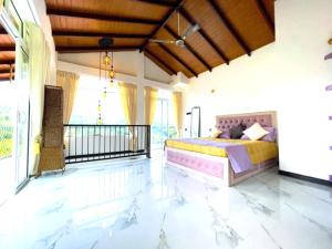 a bedroom with a bed and a balcony at The Mulberry Villa kandy in Kandy