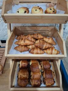 a wooden box filled with different types of pastries at Green Hôtels Bordeaux Arena in Latresne