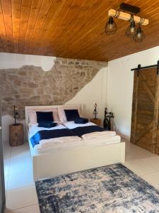 a bedroom with a large bed and a wooden ceiling at Mlýn Slavonice in Slavonice +9 photos
