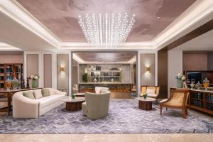 a large living room with a chandelier and furniture at Mercure Beijing Lize Road in Beijing