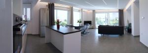 a room with a kitchen and a living room at Kassiani Studios in Keramoti