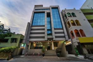 a tall building with stairs in front of it at Treebo ESS Grande in Coimbatore