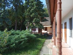 a porch of a house with a pole at Nimród vendégház in Mőcsény