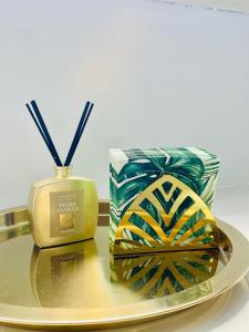 a plate with a candle and a box on a table at Zagara Suite in Francofonte
