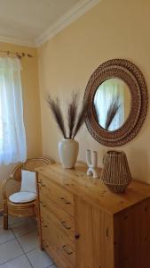 a wooden dresser with a mirror on top of it at Margaréta Apartman in Balatonudvari