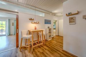 a dining room with a table and chairs at Fewo Strandliebe in Gaienhofen +5 photos