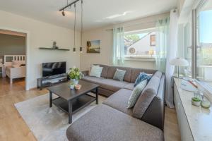 a living room with a couch and a table at Fewo Strandliebe in Gaienhofen