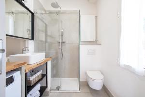 a bathroom with a shower and a toilet and a sink at Emy House Charming Apt Stunning Views Balcony AC in Carate Urio +19 photos