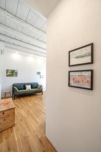 a living room with a couch against a wall at Emy House Charming Apt Stunning Views Balcony AC in Carate Urio