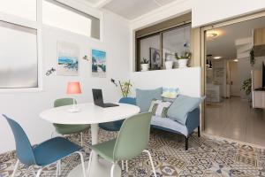 a dining room with a white table and blue chairs at CarpeDiem Costa de Antigua in Costa de Antigua