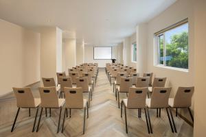 a room with rows of chairs and a podium at Ginger Pantnagar in Pantnagar