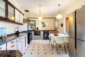 a kitchen with white cabinets and a table and chairs at Villa Vista Ajo in Ajo +27 photos
