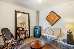 a living room with a chair and a mirror at Villa Vista Ajo in Ajo