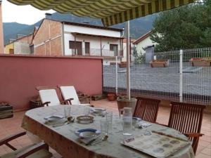 a table with plates and glasses on a patio at Pis Relapieso in Vilaller