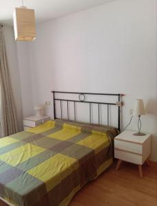 a bedroom with a bed and a table and a lamp at Pis Relapieso in Vilaller