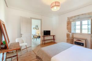 a bedroom with a bed and a desk and a fireplace at Villa Vista Ajo in Ajo