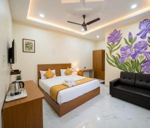 a bedroom with a bed and a flower mural on the wall at Jay & Jas Hotel in Tirupati