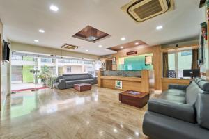 a large living room with couches and a bar at Treebo ESS Grande in Coimbatore