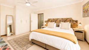 a bedroom with a large bed and a mirror at Ark de Triomphe in Riebeek-Wes +15 photos
