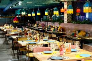 a restaurant with tables and chairs and lights at Sercotel Playa Canteras in Las Palmas de Gran Canaria