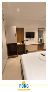 a hotel room with a bed and a tv at SW Hotel MG Road in Bangalore