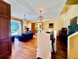 a dining room and living room with a table and chairs at Palm Villa Ammes in Svoronata +54 photos