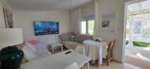 a living room with a couch and a table at Casita Costa in Miengo