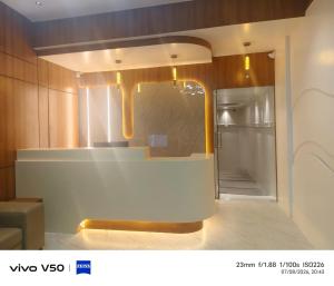 a kitchen with a counter and a refrigerator in a room at SW Hotel MG Road in Bangalore