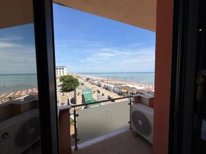 a view of the beach from a balcony of a condo at Residenza La Signora vista mare con ascensore in Marotta