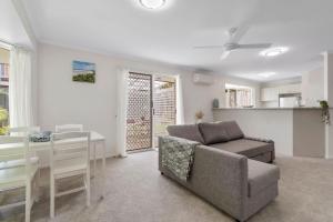 a living room with a couch and a table at Cozy 2BR villa in Maroochydore in Maroochydore