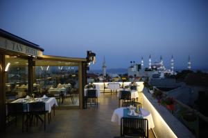 a restaurant with tables and chairs on a balcony at Tan Hotel - Special Category in Istanbul