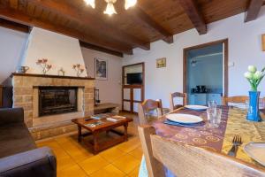 a living room with a table and a fireplace at Gîte l'anémone 6/7 personnes in Saint-Pierre-des-Tripiers +14 photos