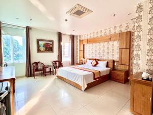 a bedroom with a bed and a table and chairs at Chu Long Hotel & Spa in Cat Ba +31 photos