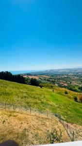 a view of a field of grass with a fence at Linoq in Montepagano