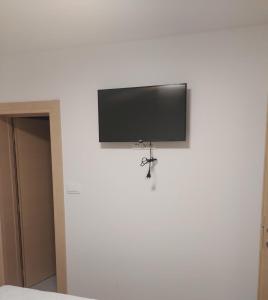 a flat screen tv hanging on a wall at Apartmani Đurišić in Posušje