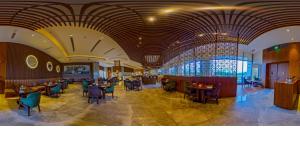 a restaurant with tables and chairs in a room at Radisson Hotel Delhi MG Road in New Delhi