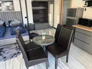a small room with a table and chairs and a bed at Csiszta Thermal Villa in Buzsák