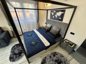 a bedroom with a bed with blue sheets and pillows at Csiszta Thermal Villa in Buzsák