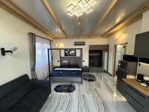 a living room with a couch and a table at Csiszta Thermal Villa in Buzsák