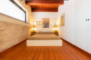 a bedroom with a bed and a brick wall at Residenza Michetti in Francavilla al Mare +36 photos
