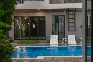 a swimming pool in front of a building at The Lucky Beach Ao Nang in Ao Nang Beach