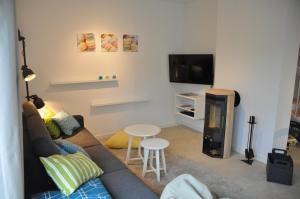 a living room with a couch and a fire place at Ferienhaus Wiekhus in Breege