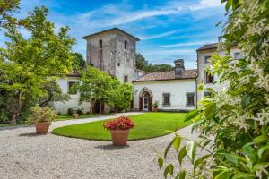 an estate with a large building with a tower at Villa Verecondi Scortecci in Colle Umberto