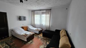 a living room with a couch and a bed at Keja II in Łeba